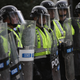 Members of the Virginia State Police stand guard in riot gear on the campus of the University of Virginia during an event marking the one year anniversary of a deadly clash between white supremacists and counter protesters August 11, 2018 i